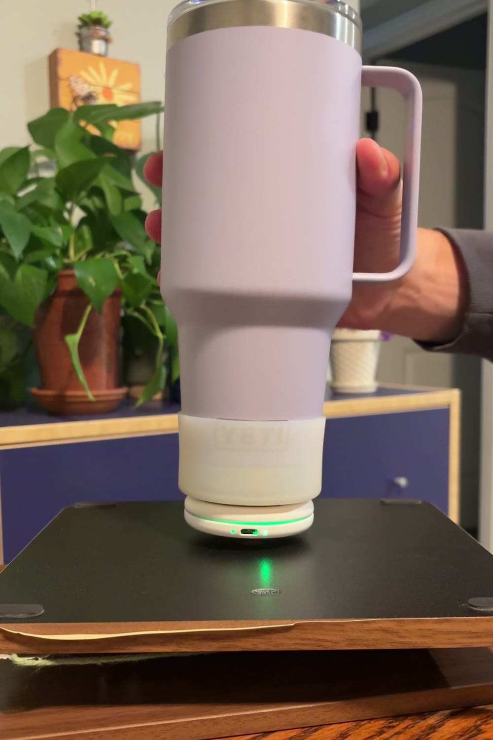 Setting a bottle down with the Sponge tracker attached underneath, status light glowing